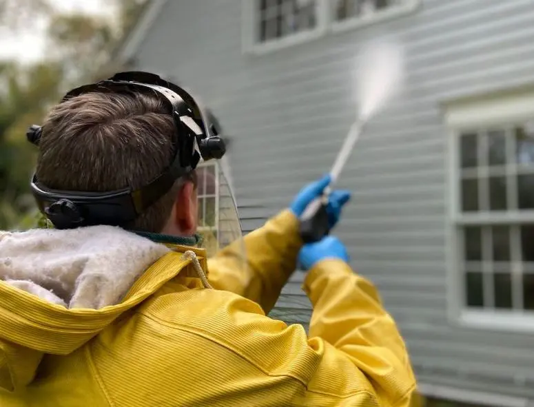 man pressure washing