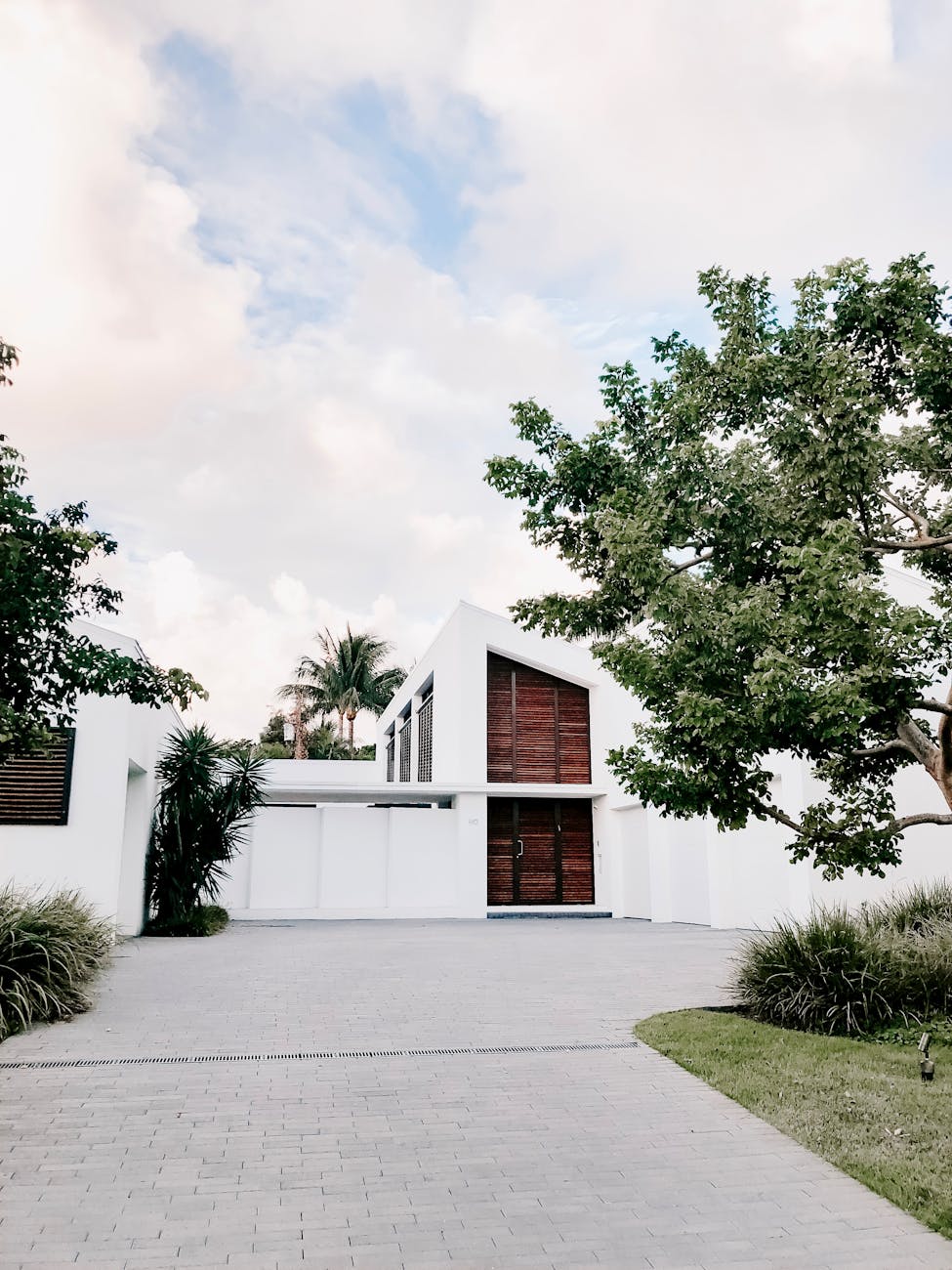 white and brown house with driveway to show potential pressure washing results